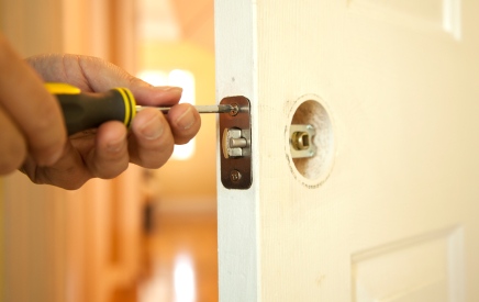 Handyman in Bunker Hill Village, TX fixing door.